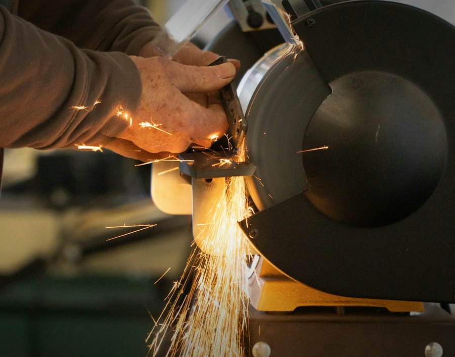 Worker cutting metal with an angle grinder