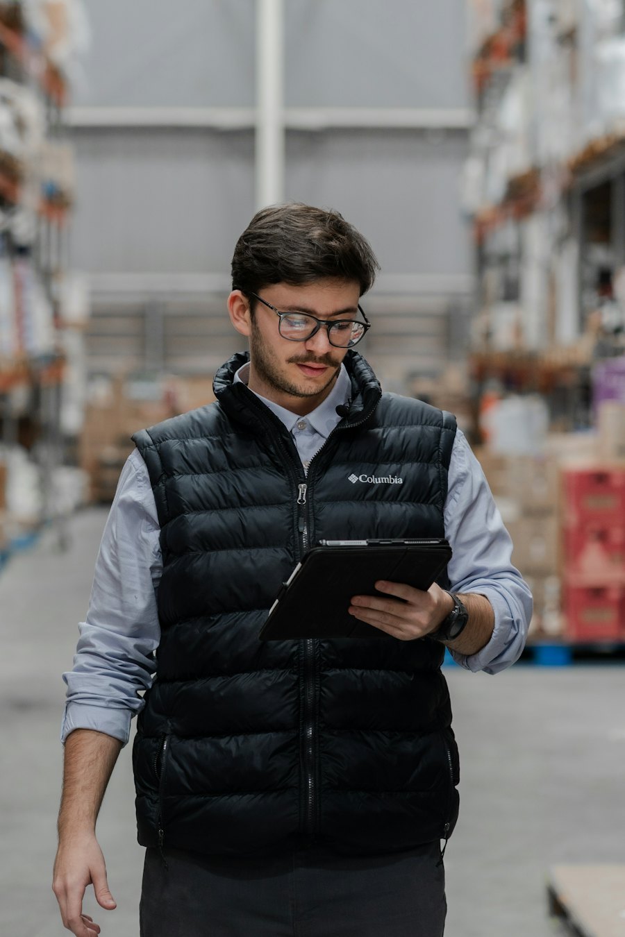 Manager checking scrap metal records on a tablet